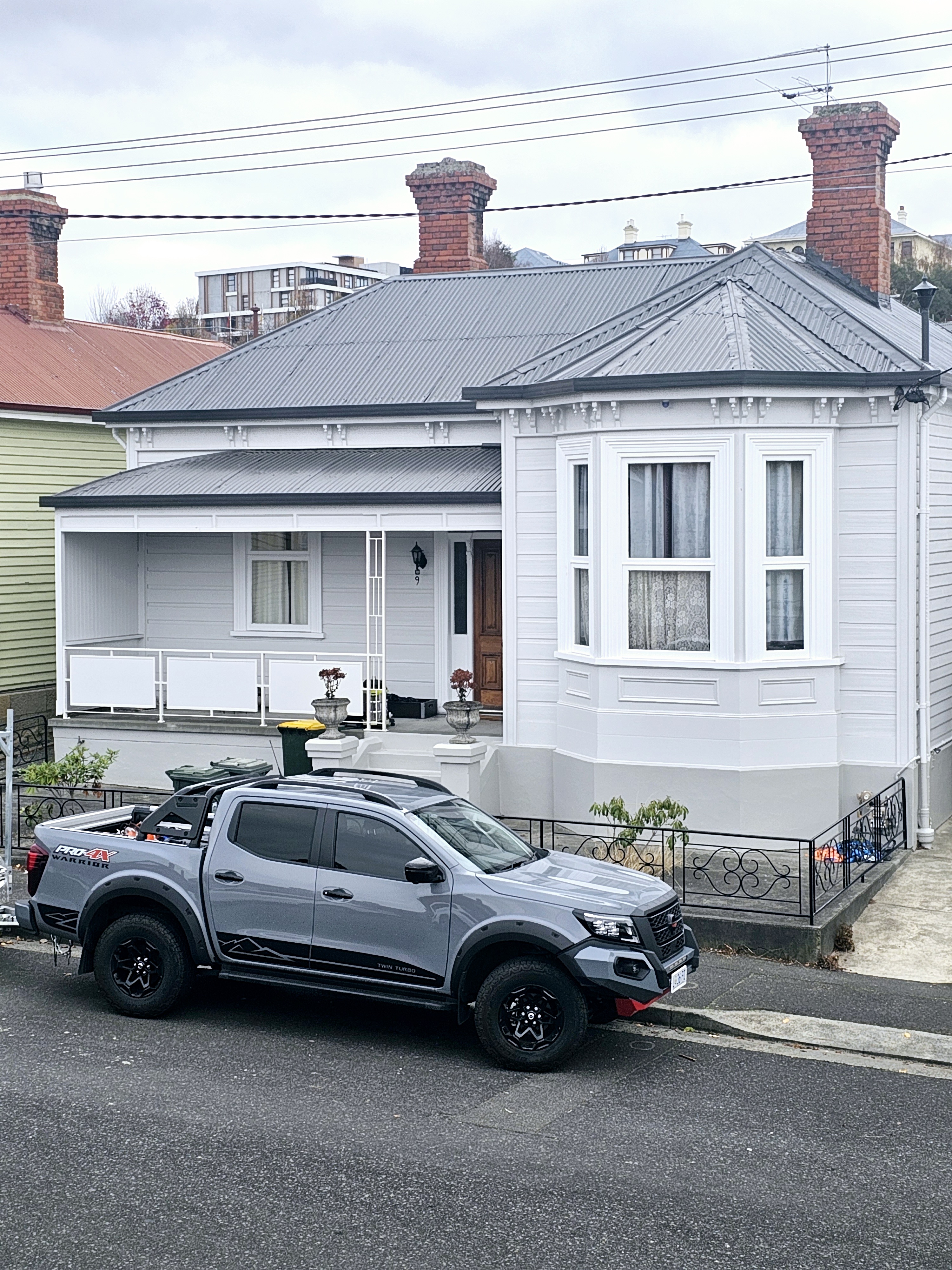 painter-wolfes-painting-hobart Finished weatherboard exterior with wolfes painting car out the front